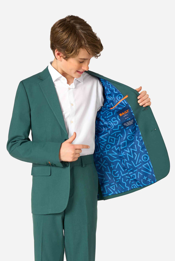 Teen boy wearing a stylish dark green suit with a white dress shirt, smiling confidently. Perfect formal outfit for boys' special occasions, weddings, and parties. Kid holding one side of the jacket open.