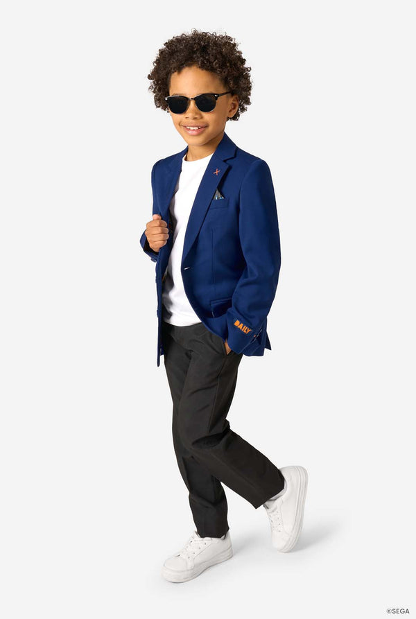 Child wearing a blue blazer, white shirt, black pants, and sunglasses on a white background
