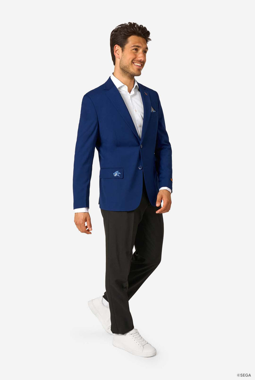 Man wearing a blue blazer with a white shirt and black pants on a white background