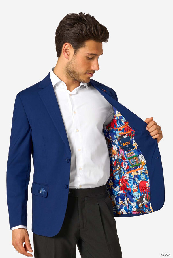 Man wearing a blue blazer with a colorful interior, standing against a white background