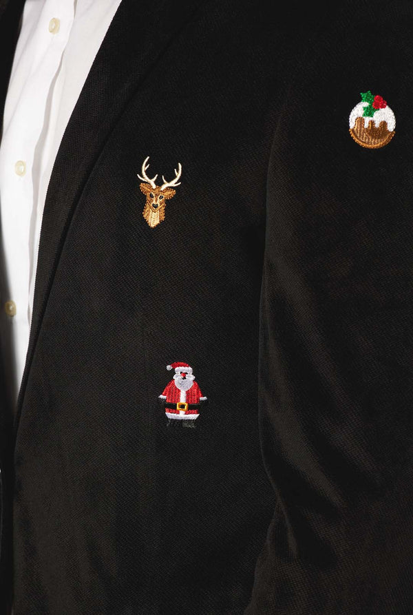 Man wearing black Christmas blazer with Christmas icons, close up