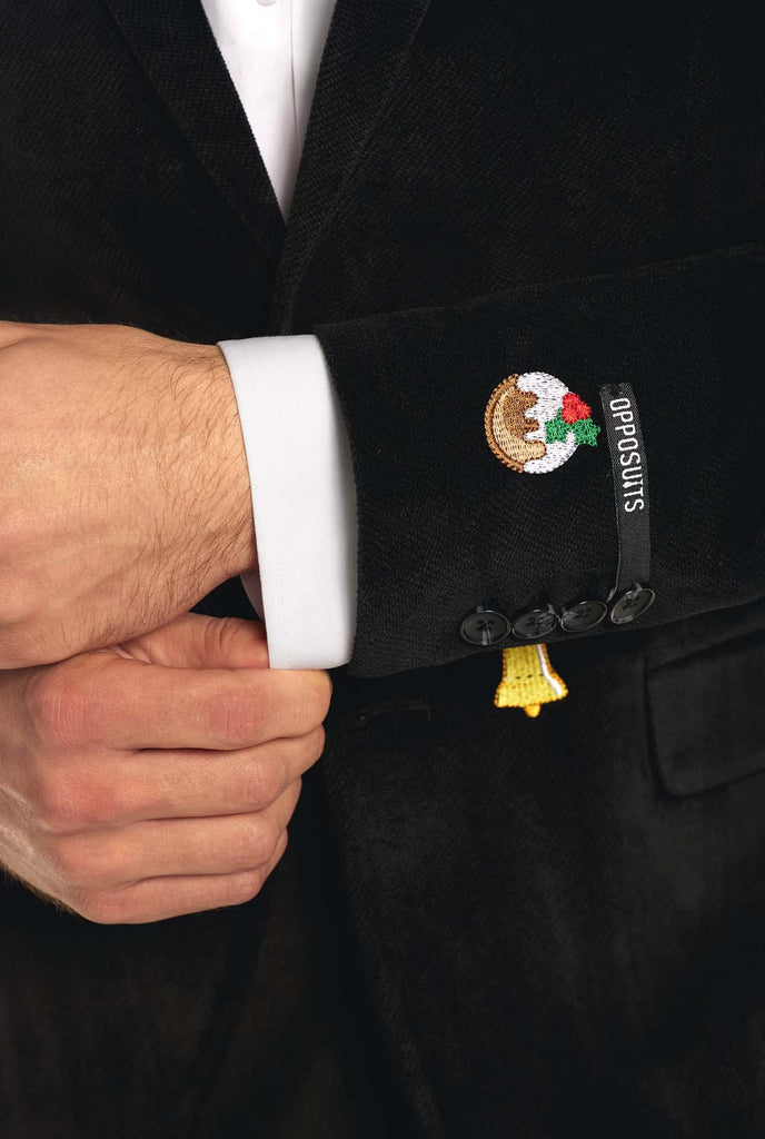 Man wearing black Christmas blazer with Christmas icons, sleeve close up