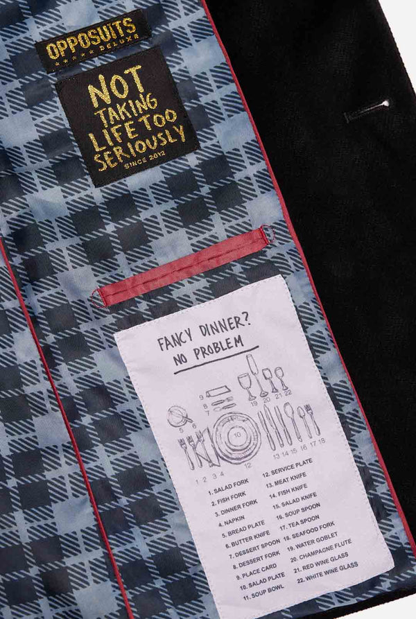 Man wearing black Christmas blazer with Christmas icons, close up inside