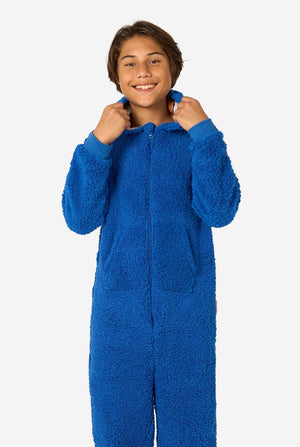 A kid is wearing a blue sesame street onesie resembling Cookie Monster. 