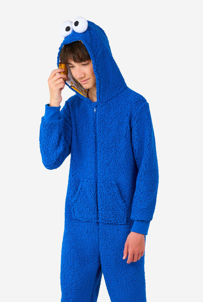 Kid wearing blue pluche Cookie Monster onesie