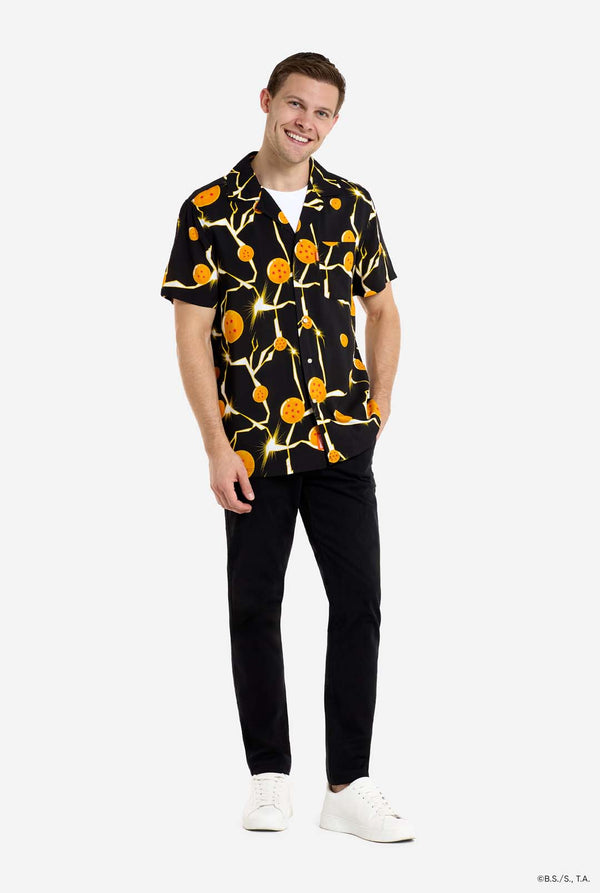 Man wearing black Hawaiian shirt with Dragon Ball Z print, showings Dragon Balls and lighting. He is also wearing a white t-shirt and black pants. Full body image.
