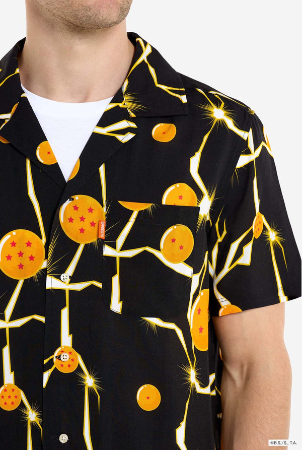 Man wearing black Hawaiian shirt with Dragon Ball Z print, showings Dragon Balls and lighting. He is also wearing a white t-shirt and black pants. Chest close up.