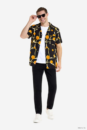 Man wearing black Hawaiian shirt with Dragon Ball Z print, showings Dragon Balls and lighting. He is also wearing a white t-shirt and black pants. Full body image and wearing sunglasses.