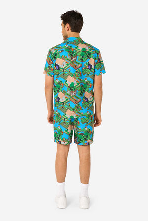 A man wearing a colorful summer outfit featuring a Minecraft Overworld print, showcasing pixelated landscapes, characters, and elements from the iconic game. The short-sleeve shirt and matching shorts highlight a vibrant design inspired by the Minecraft universe. View from the back.