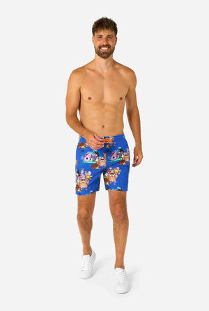 Men's blue Dragon Ball-themed swim shorts featuring Goku, Krillin, Master Roshi, and other characters at Kame House. Perfect for anime fans at the beach or pool. 