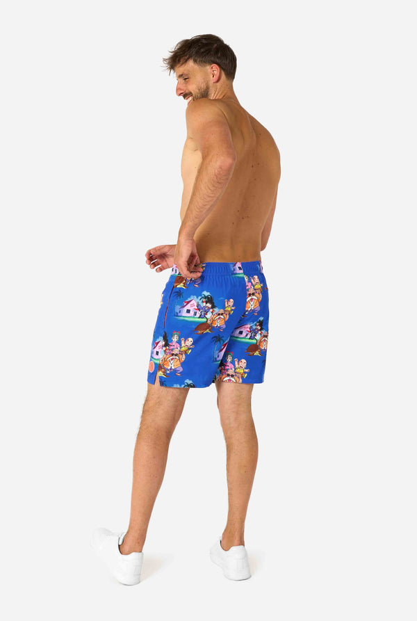 Men's blue Dragon Ball-themed swim shorts featuring Goku, Krillin, Master Roshi, and other characters at Kame House. Perfect for anime fans at the beach or pool. 