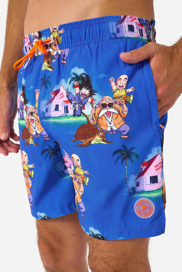 Men's blue Dragon Ball-themed swim shorts featuring Goku, Krillin, Master Roshi, and other characters at Kame House. Perfect for anime fans at the beach or pool. 