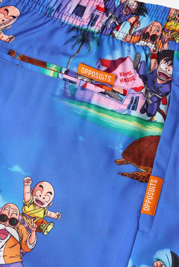 Men's blue Dragon Ball-themed swim shorts featuring Goku, Krillin, Master Roshi, and other characters at Kame House. Perfect for anime fans at the beach or pool. 