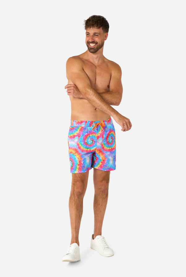 Men's rainbow tie-dye swim shorts with a bold, colorful spiral pattern. A fun and trendy choice for beach days and pool parties.