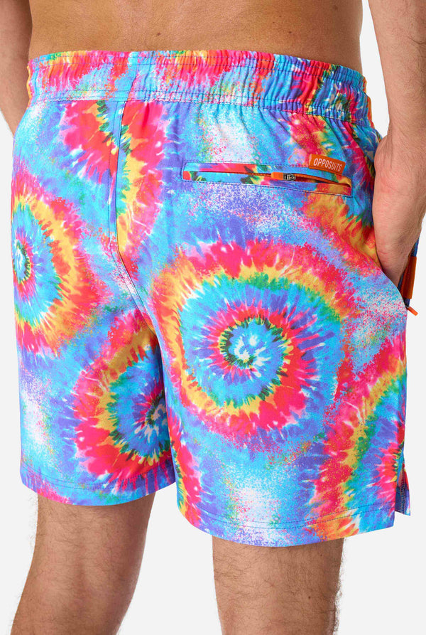 Men's rainbow tie-dye swim shorts with a bold, colorful spiral pattern. A fun and trendy choice for beach days and pool parties.