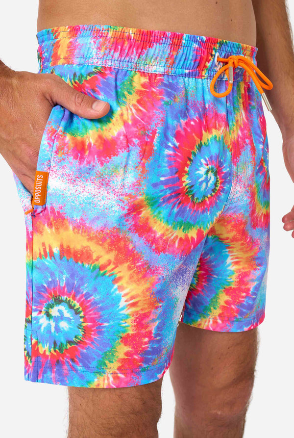 Men's rainbow tie-dye swim shorts with a bold, colorful spiral pattern. A fun and trendy choice for beach days and pool parties.