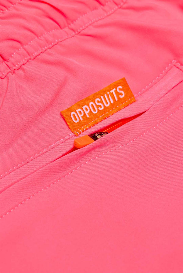 Man wearing Neon Pink Power swim trunks for men, close up