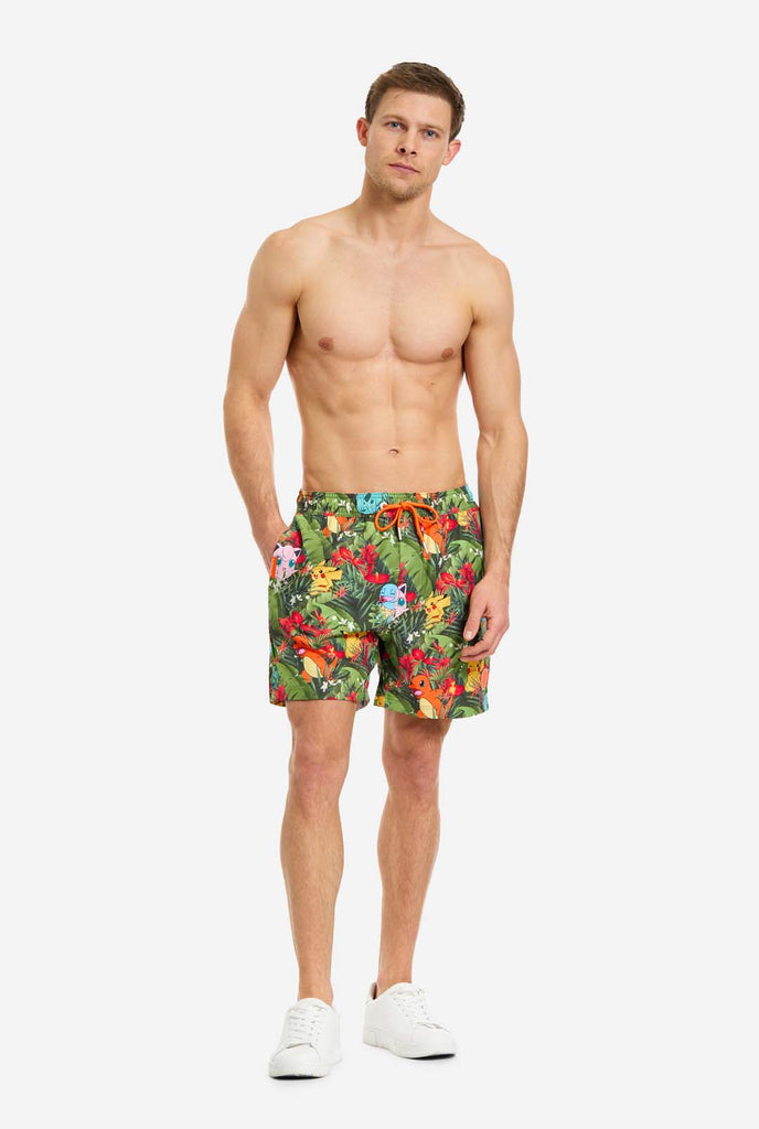 Man wearing swim trunks with Pokemon forest print