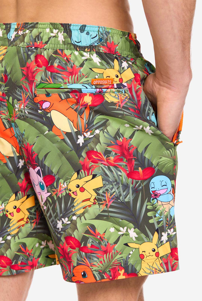 Man wearing swim trunks with Pokemon forest print, close up