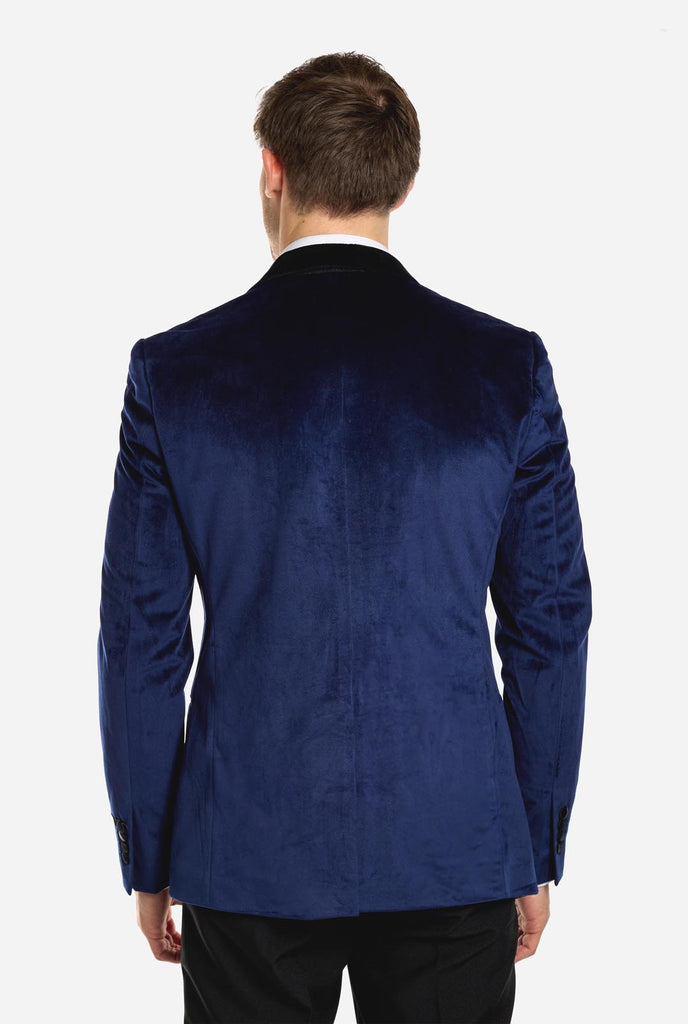 Man wearing navy blue dinner jacket blazer, view from the back