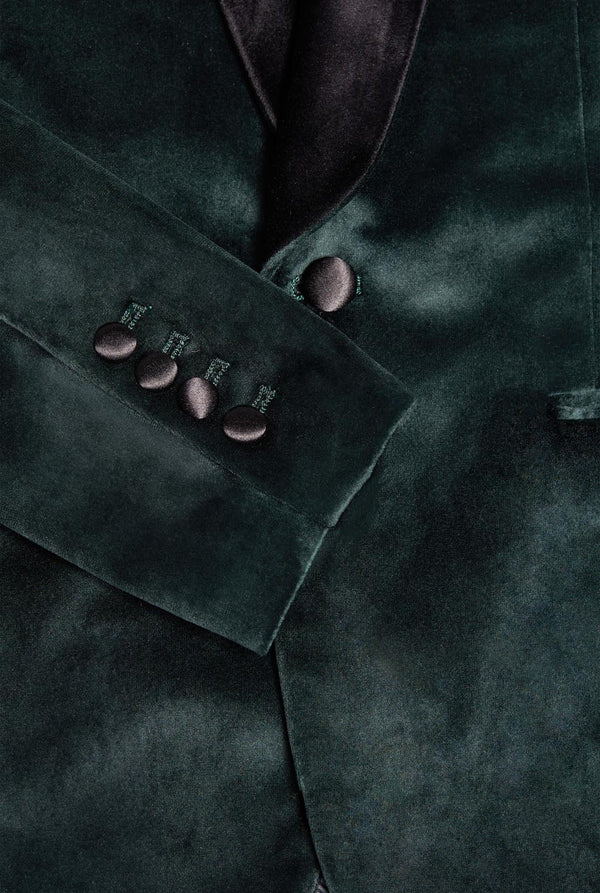 Man wearing dark green dinner jacket blazer, close up