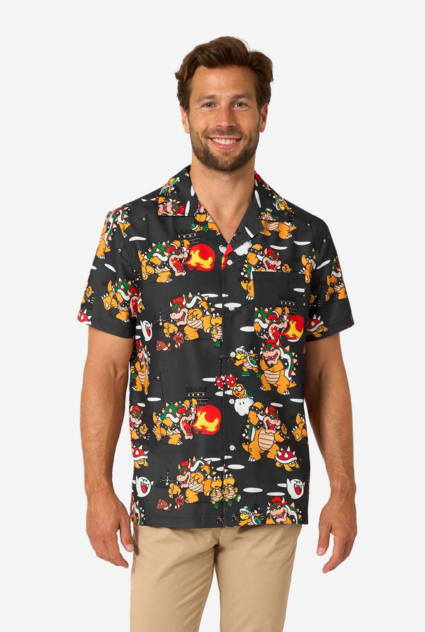 Man wearing short-sleeve black Bowser’s Mayhem shirt with colorful Bowser print.