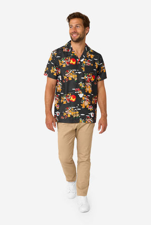 Full-body view of man in Bowser’s Mayhem shirt paired with beige pants and white sneakers.