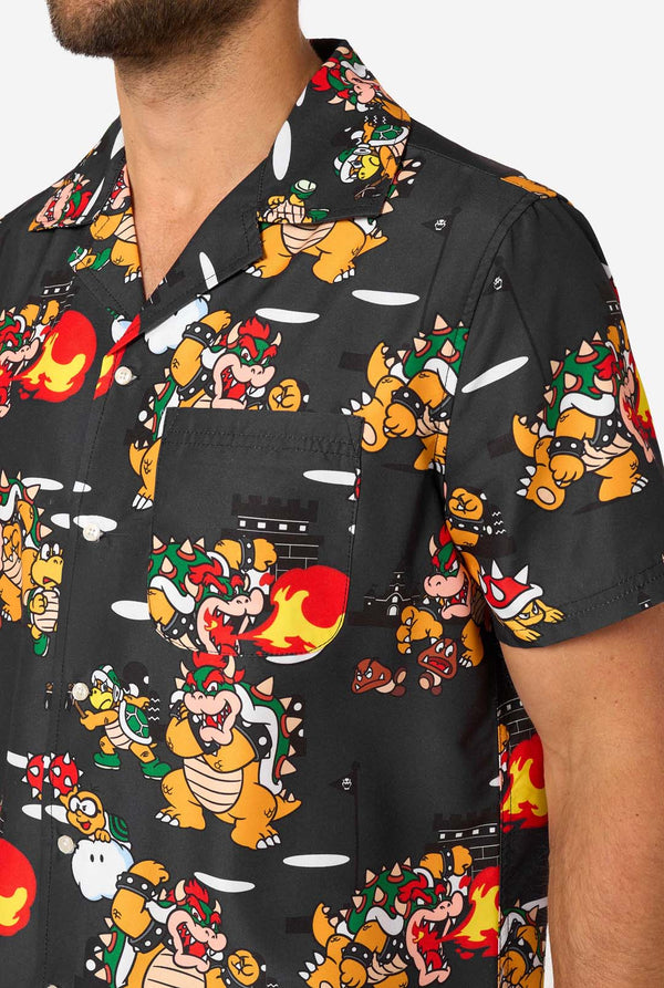 Close-up of Bowser’s Mayhem shirt with pocket and detailed Bowser print on black fabric.