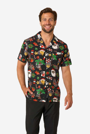 Man wearing a colorful, patterned Christmas shirt on a white background