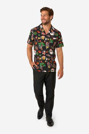 Man wearing a colorful, patterned Christmas shirt on a white background. Full body image