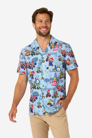 Man wearing light blue short-sleeve Mario Kart shirt with colorful character print.
