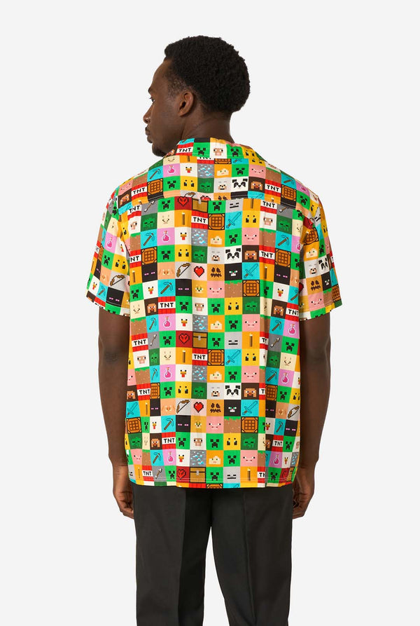Man wearing a colorful Minecraft Hawaiian shirt featuring pixelated blocks, characters, and items from the game, paired with black pants, standing against a plain white background. View from the back