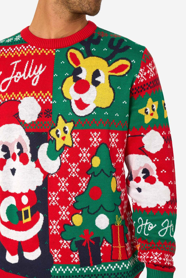 Smiling man wearing a colorful knitted Christmas sweater featuring Santa Claus, Rudolph, and the text “So Jolly.” Close-up.