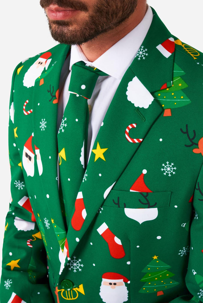 Man wearing green Christmas suits for men with Christmas icons, chest close up