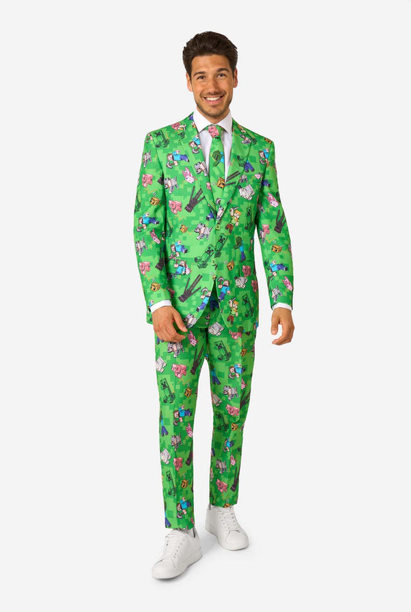 Full-body image of a man in a green Minecraft-themed suit by OppoSuits, smiling and posing confidently.