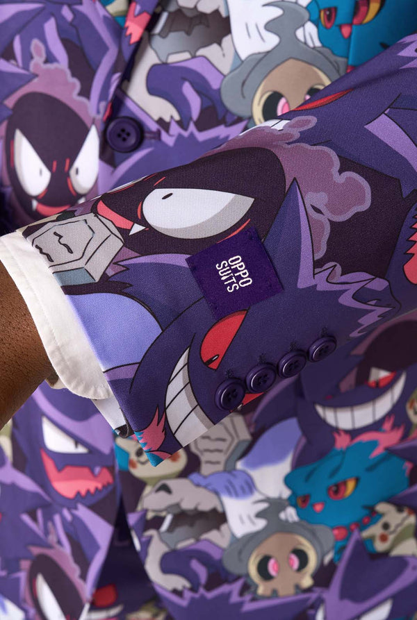 A man wearing a Ghost Pokemon themed suit with a Ghost Pokemon themed tie and a white shirt on a white background. Close up of the sleeves
