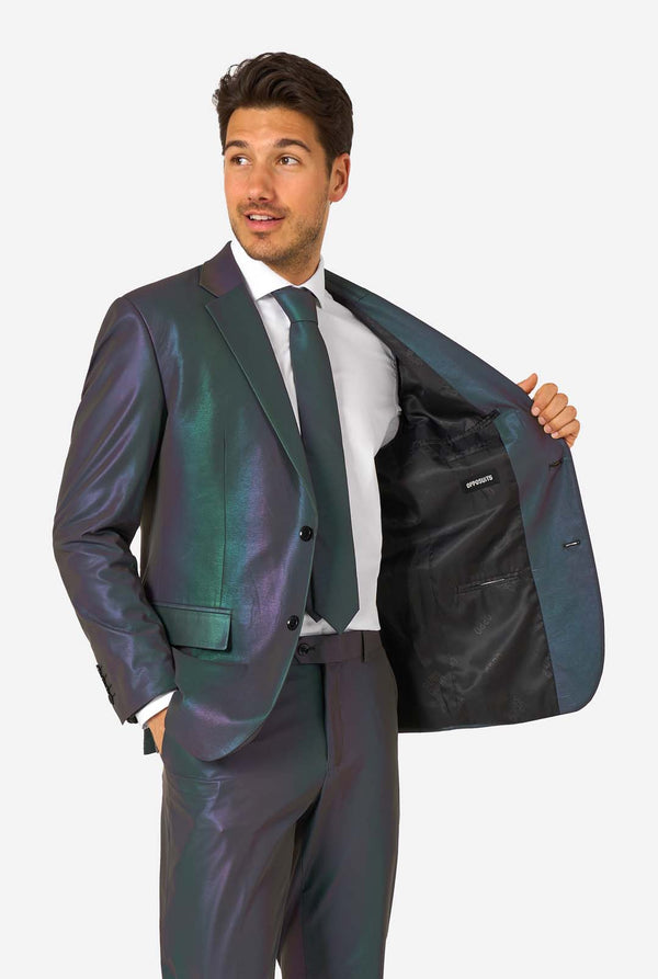 A man wearing a reflective suit, with a reflective tie and a white shirt on a white background. Holding his jacket open