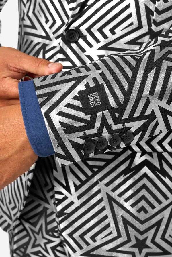 Detailed view of blazer sleeve cuff featuring three black buttons and embroidered OppoSuits label on geometric silver fabric.