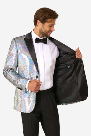 Man smiling while holding open a holographic silver sequin tuxedo to reveal a solid black interior lining with an OppoSuits label.