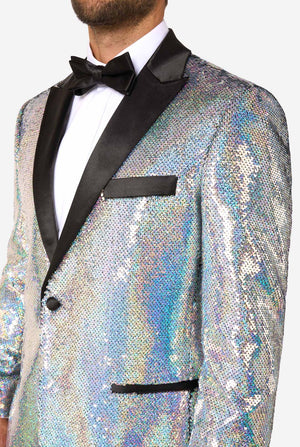 Close-up of upper body in holographic silver sequin tuxedo with black satin lapels, white shirt, and black bow tie.