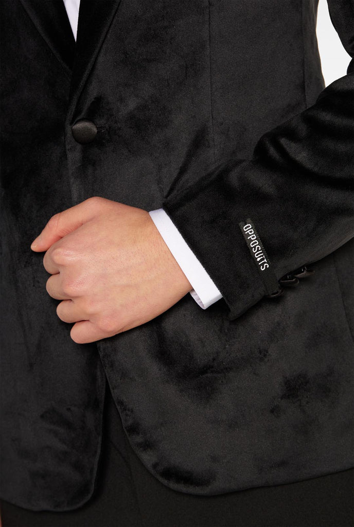 Teen wearing black velvet dinner jacket blazer for teen boys, close up