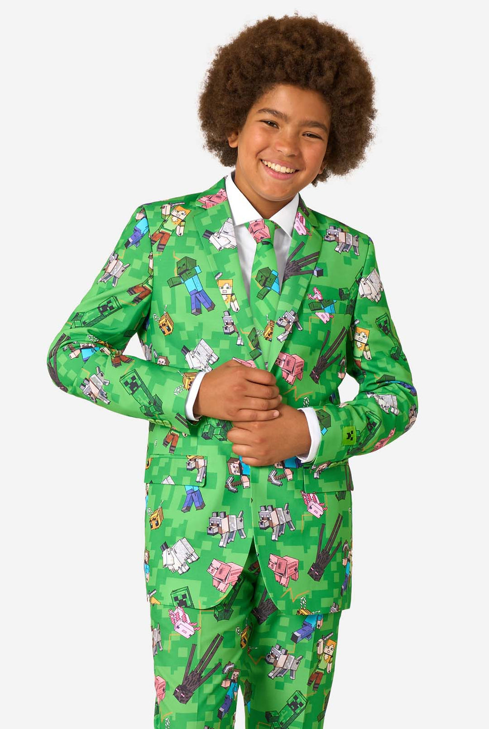 A teen boy wearing a bright green Minecraft suit with iconic characters, including Creepers and Steve 