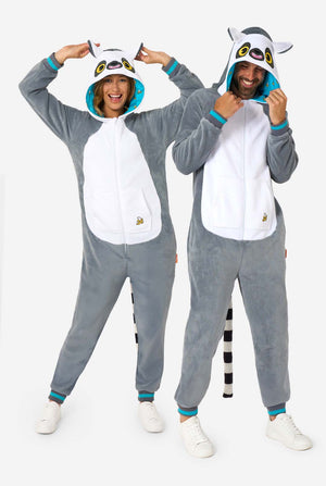 A man and women are wearing a grey and white lemur adult onesie featuring playful hood details and cozy, soft material, perfect for lounging or costume events. Including black and white tail. The hood are on their heads. Full body image.