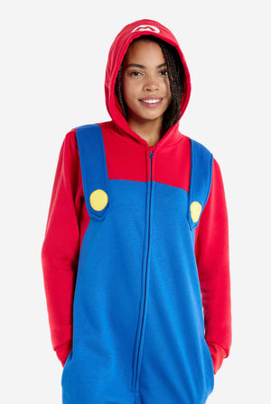 Woman wearing unisex adult onesie with Super Mario print