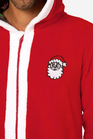 A smiling man models a cozy, red and white, hooded christmas onesie that resembles a Santa onesie. Close up of the chest