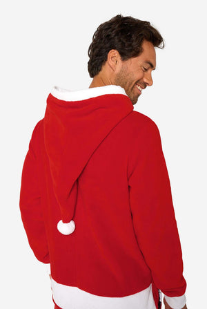A smiling man models a cozy, red and white, hooded christmas onesie that resembles a Santa onesie.