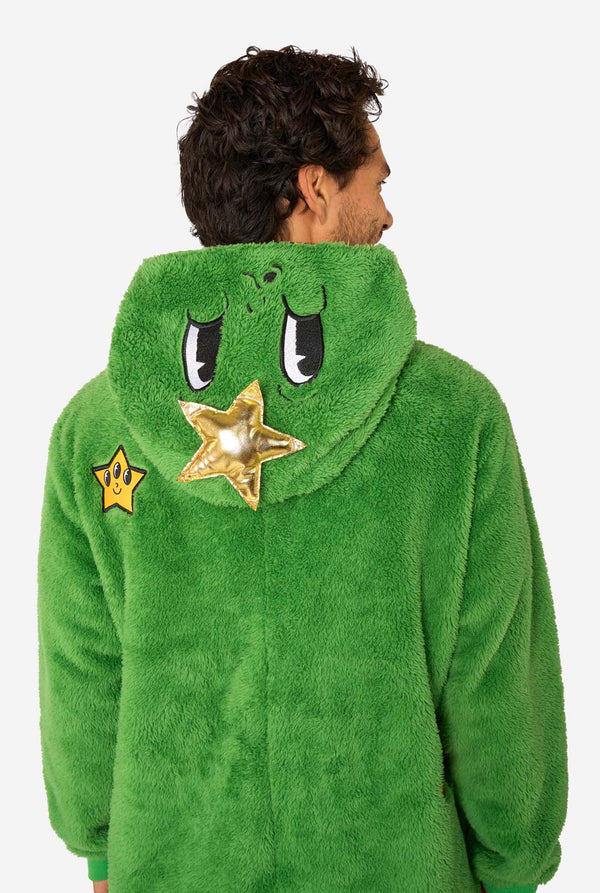 A smiling man wearing a green Christmas onesie designed to look like a Christmas tree, decorated with cartoon ornaments and stars. Close up of the hood.