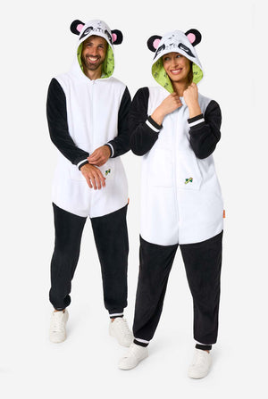 A man and woman are wearing a panda-themed adult onesie. This cozy onesie features black and white panda colors with a playful hood showcasing panda ears and a cute face. Perfect for lounging or fun costume occasions. Full body image.
