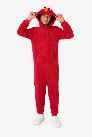 Kid is wearing a red onesie resembling Elmo. He his holding the hood.