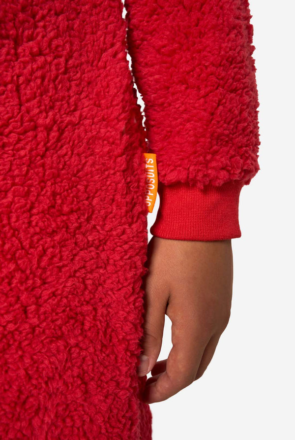 Kid is wearing a red onesie resembling Elmo. Close up.